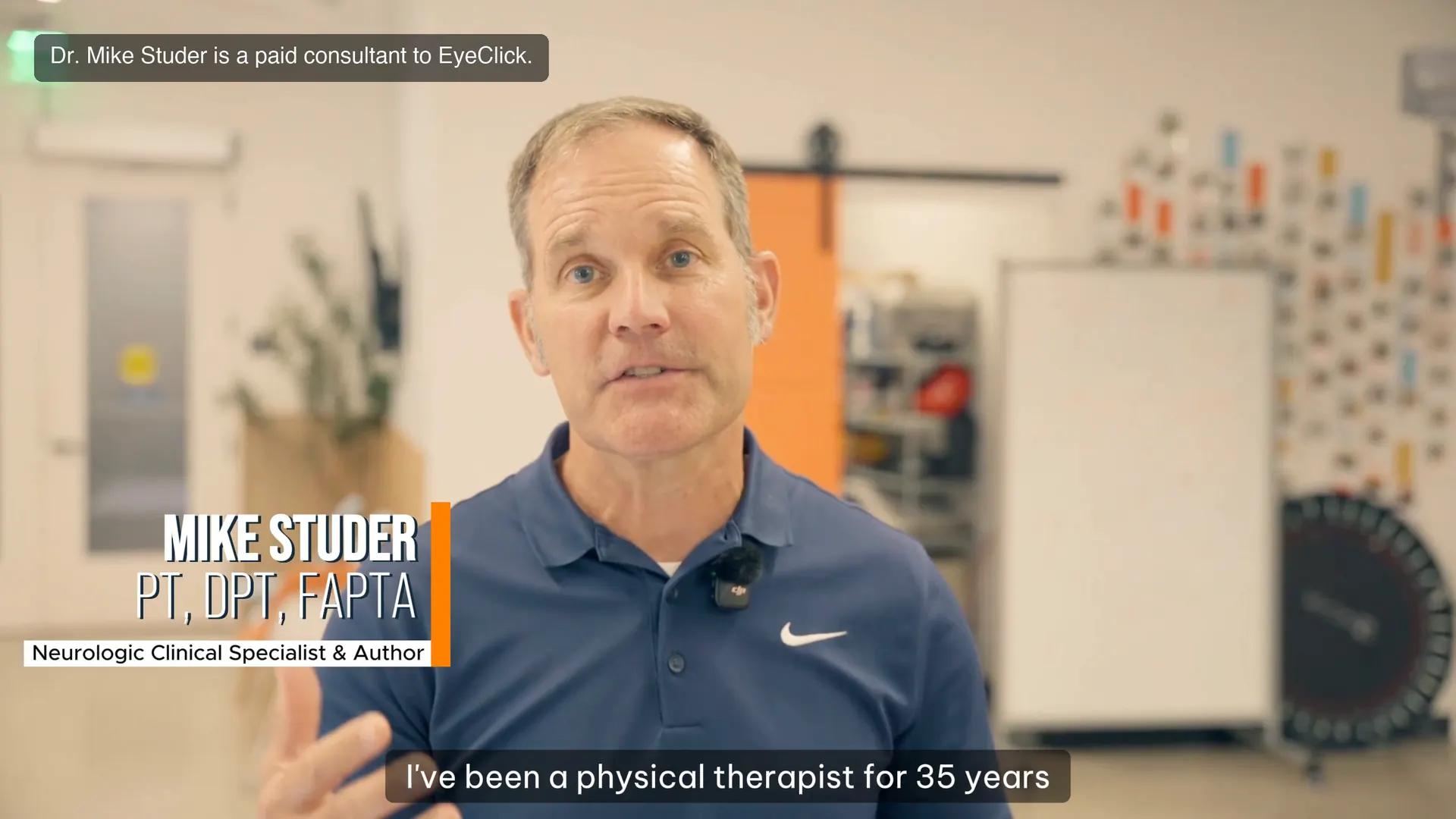 A clinician guiding a patient through a projected movement activity in a therapy gym